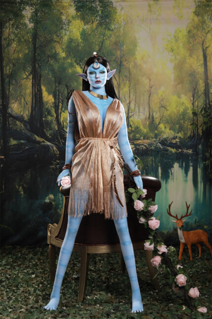 Blue-skinned fantasy character with gold dress and horns, holding roses, seated in a forest setting.
