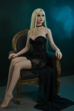 A lifelike doll with long blonde hair, wearing a black lace dress and choker, sits on an ornate chair against a dark blue background.