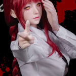 Red-haired doll with white shirt pointing finger