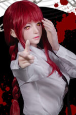 Red-haired doll with white shirt pointing finger