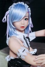 A doll with light blue hair and a white and black outfit.
