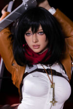 A cosplayer in a white shirt, red scarf, and brown jacket holds a large sword above their head, wearing a key necklace.